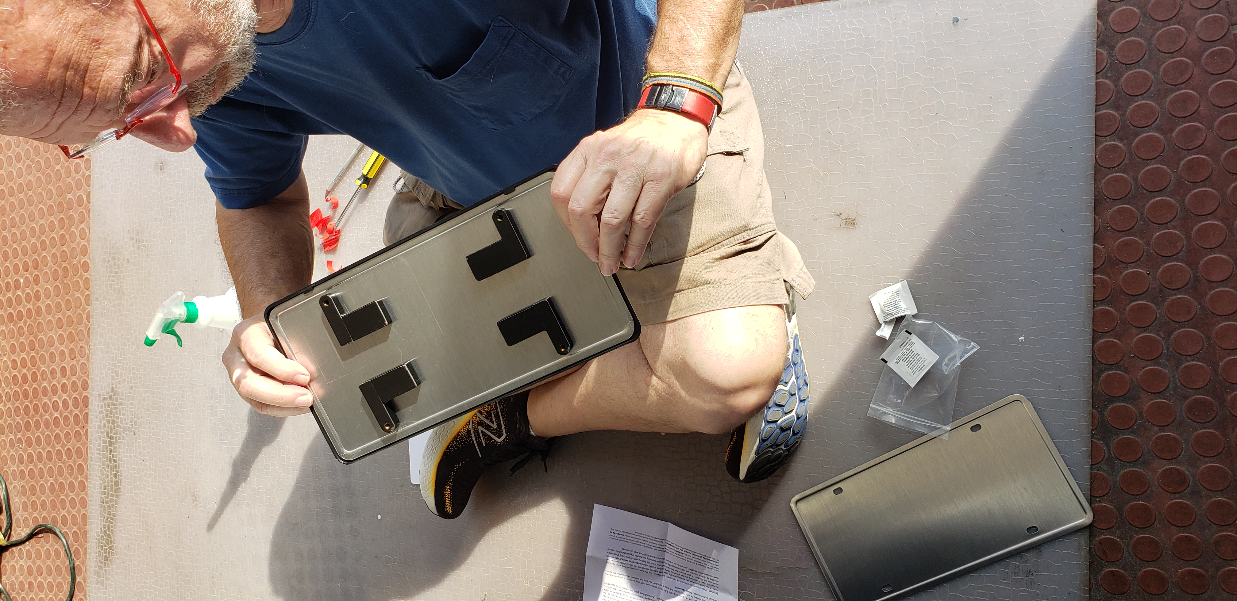 Mounting the pads to the back of the plate and frame BEFORE adhering the pads to the car. This ensures everything is properly aligned.